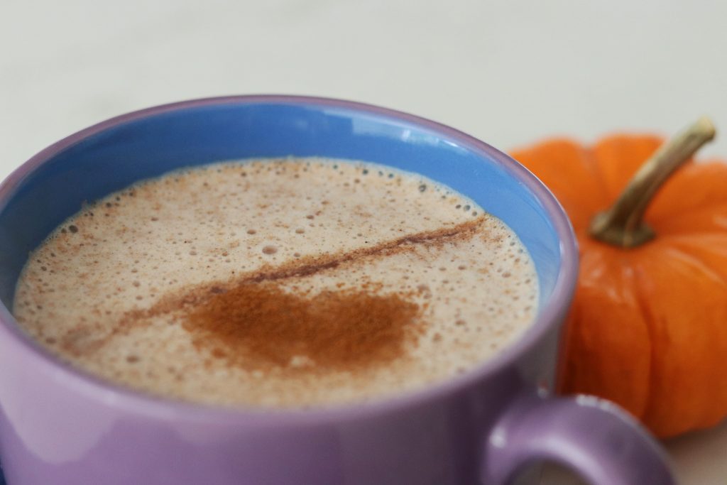 Healthy Pumpkin Spice Latte in a purple mug with a mini pumpkin in the background
