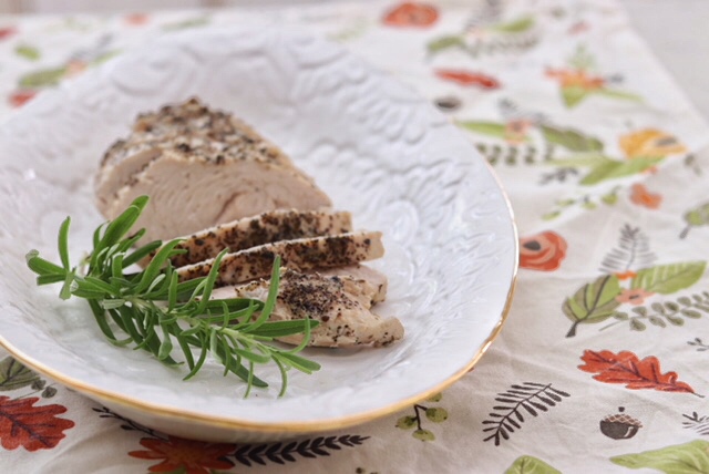 Platter with Instant Pot Turkey Tenderloin and a sprig of rosemary