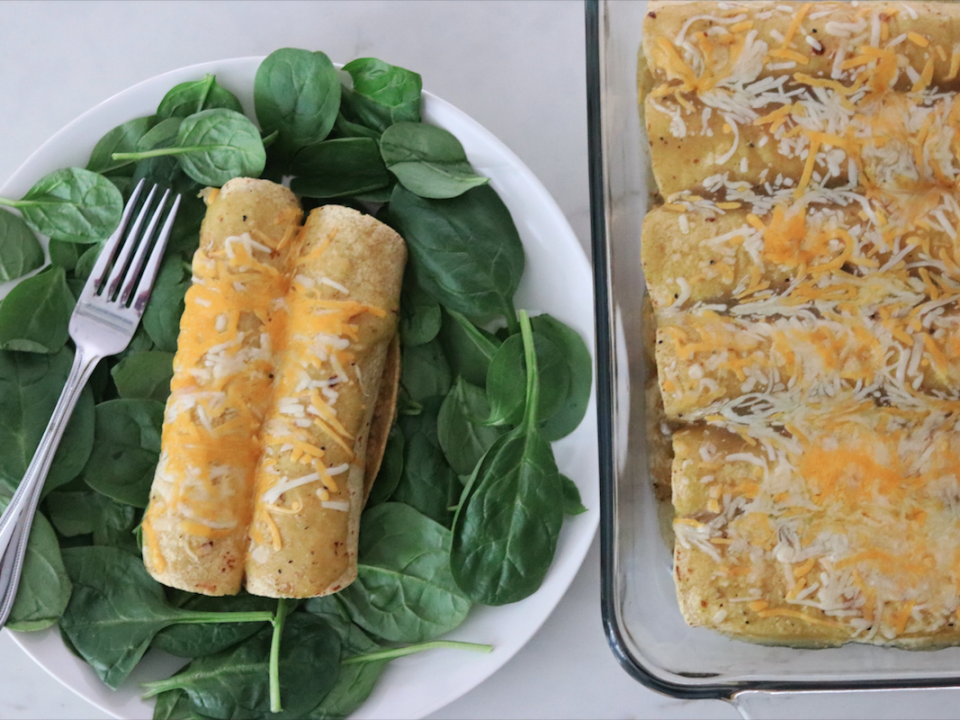 Plate of Leftover Turkey and Spinach Enchiladas with pan in the background