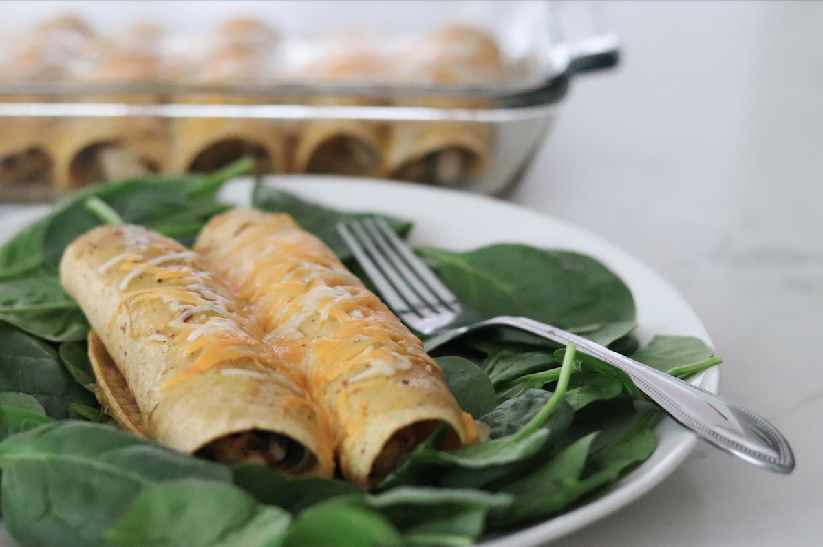 Plate of Leftover Turkey and Spinach Enchiladas with pan in the background