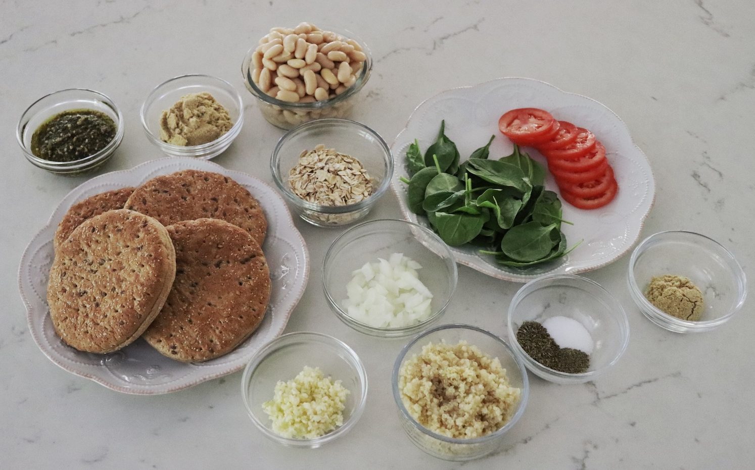 All ingredients for Flaxseed Quinoa and White Bean Burgers in small clear glass bowls