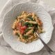 A while bowl filled with a serving of Creamy Tomato Chickpea Pasta with Spinach